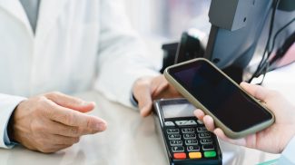 Blank screen of cellphone. Cashless wireless payment with mobile phone with mockup at drugstore
