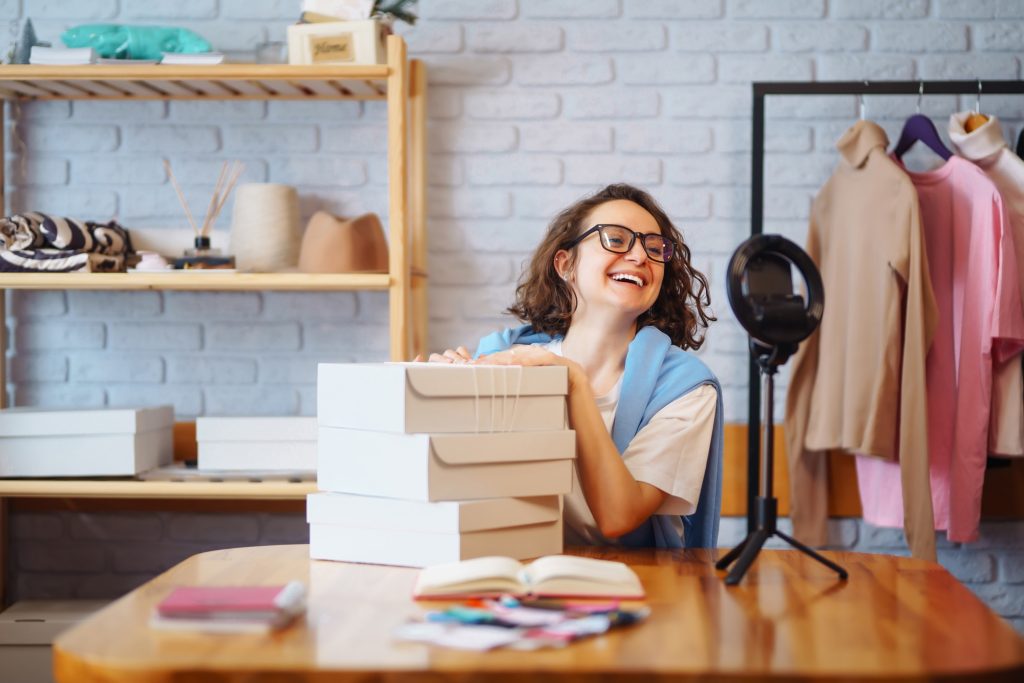 Female warehouse worker, seller, dropshipping small business owner recording new content for vlog.