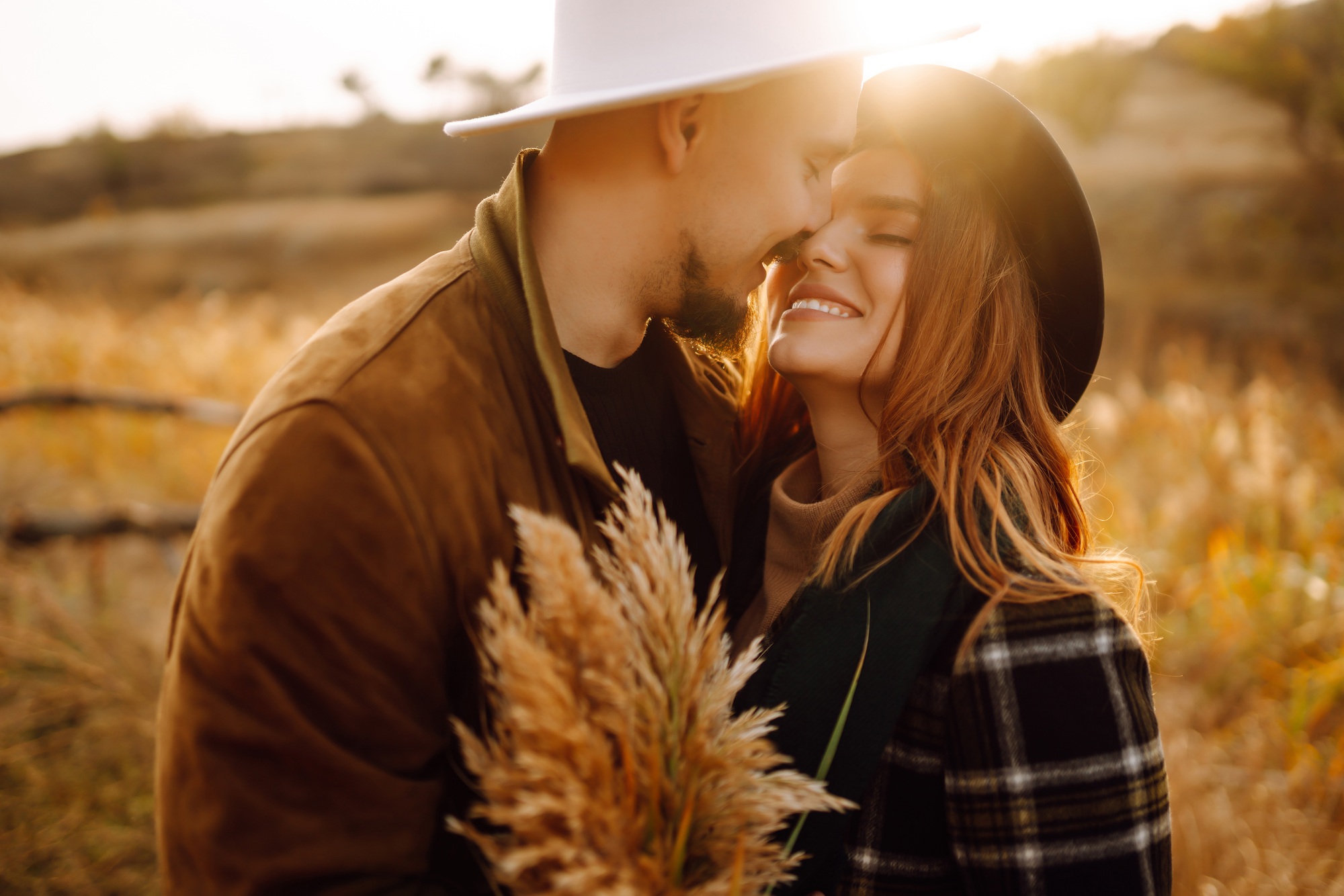 Lovely hipster couple resting in nature. People, lifestyle, relaxation and vacations concept.