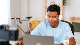 Male streamer recording tutorial from home.