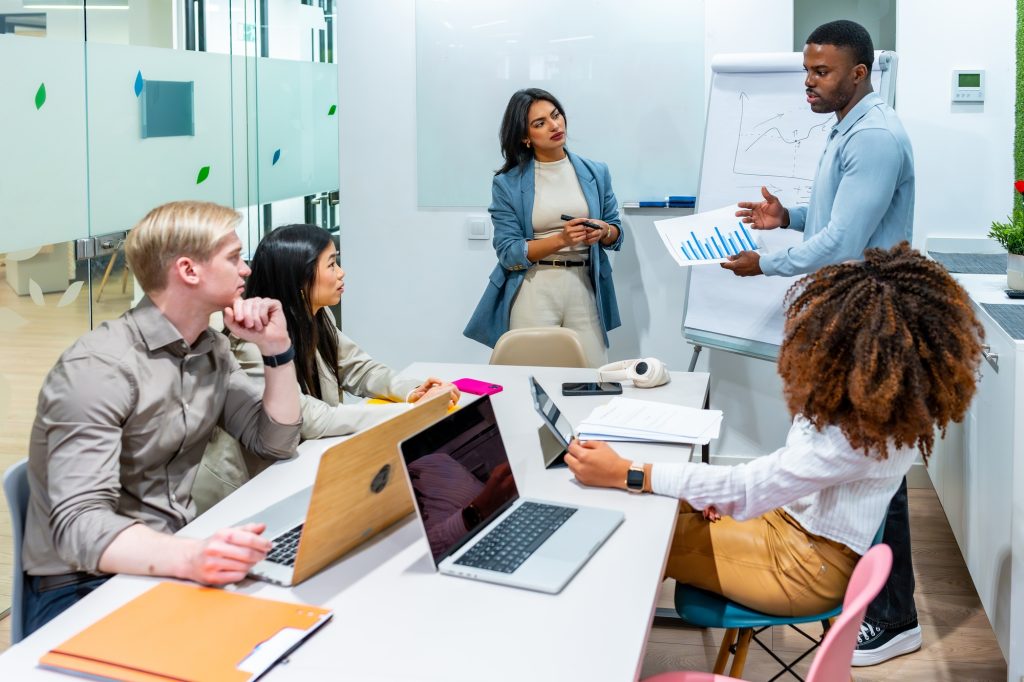 Marketing team discussing growth strategies in coworking office