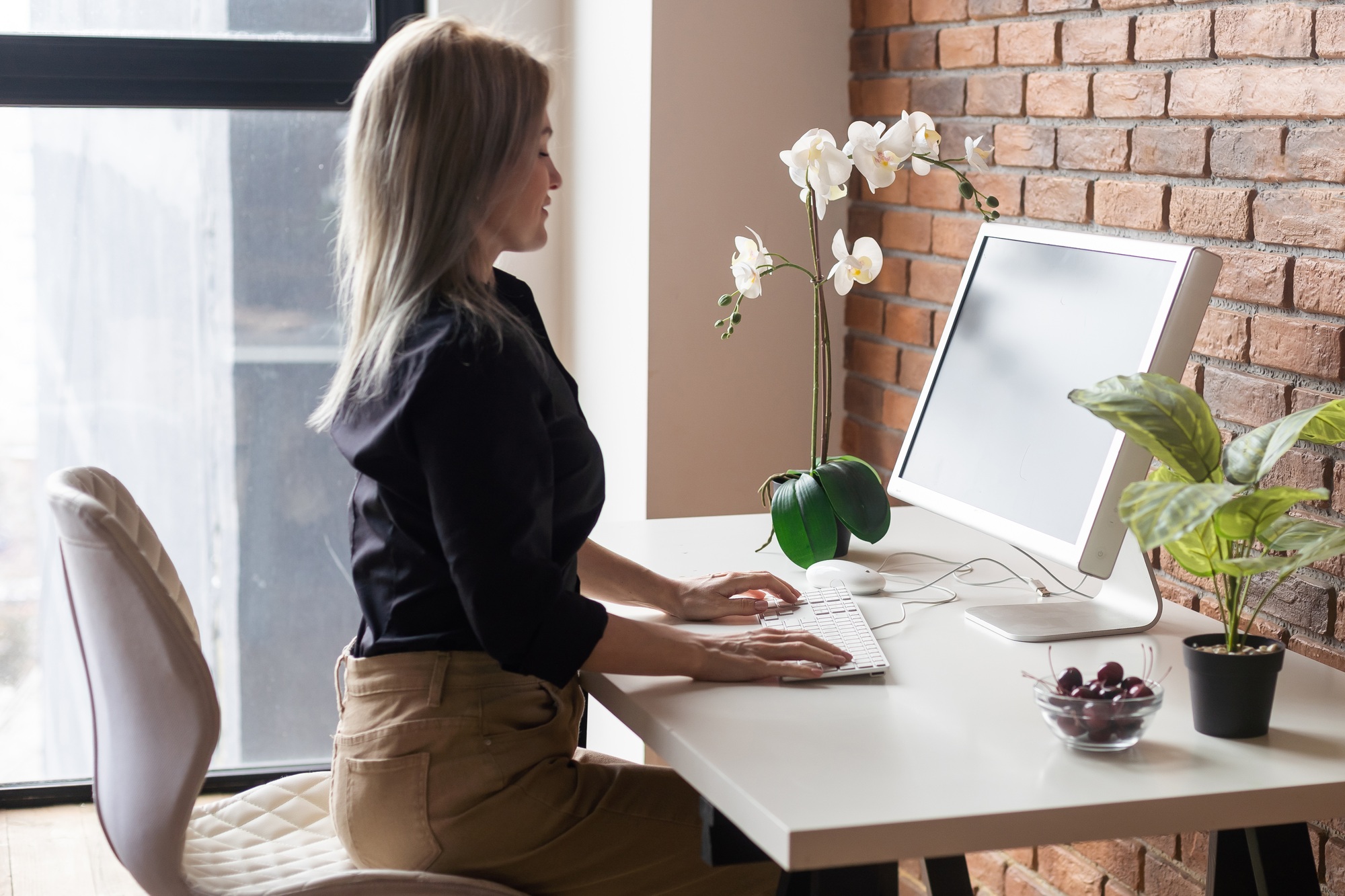 Successful female grapic designer watching tutorial about creative ideas at computer during working