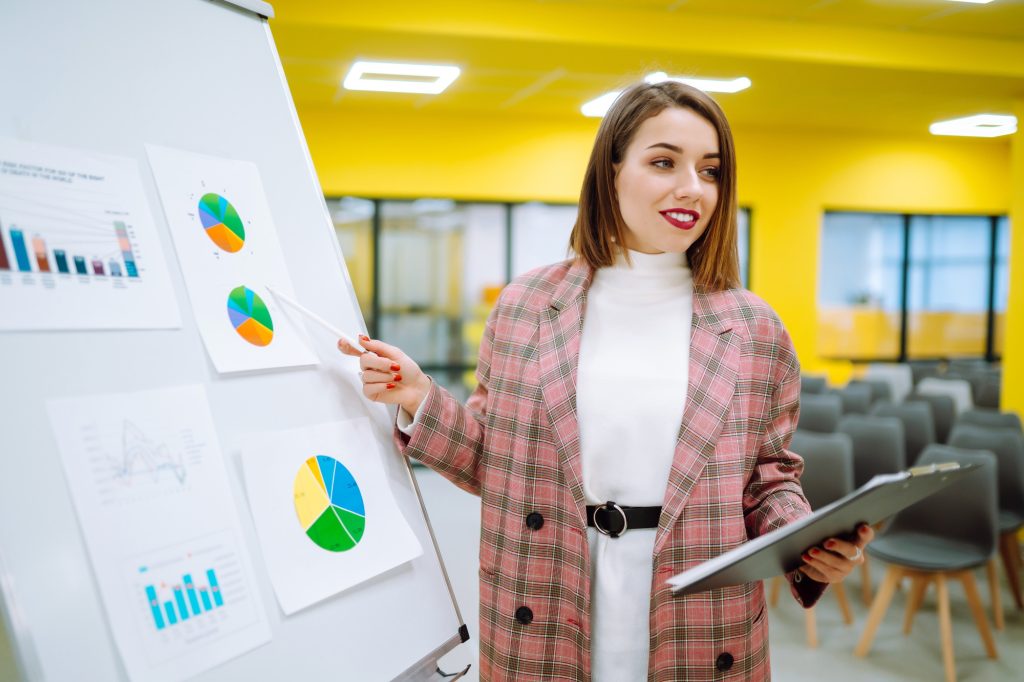 Young woman leader, presenter, make a business presentation at a conference in the office.